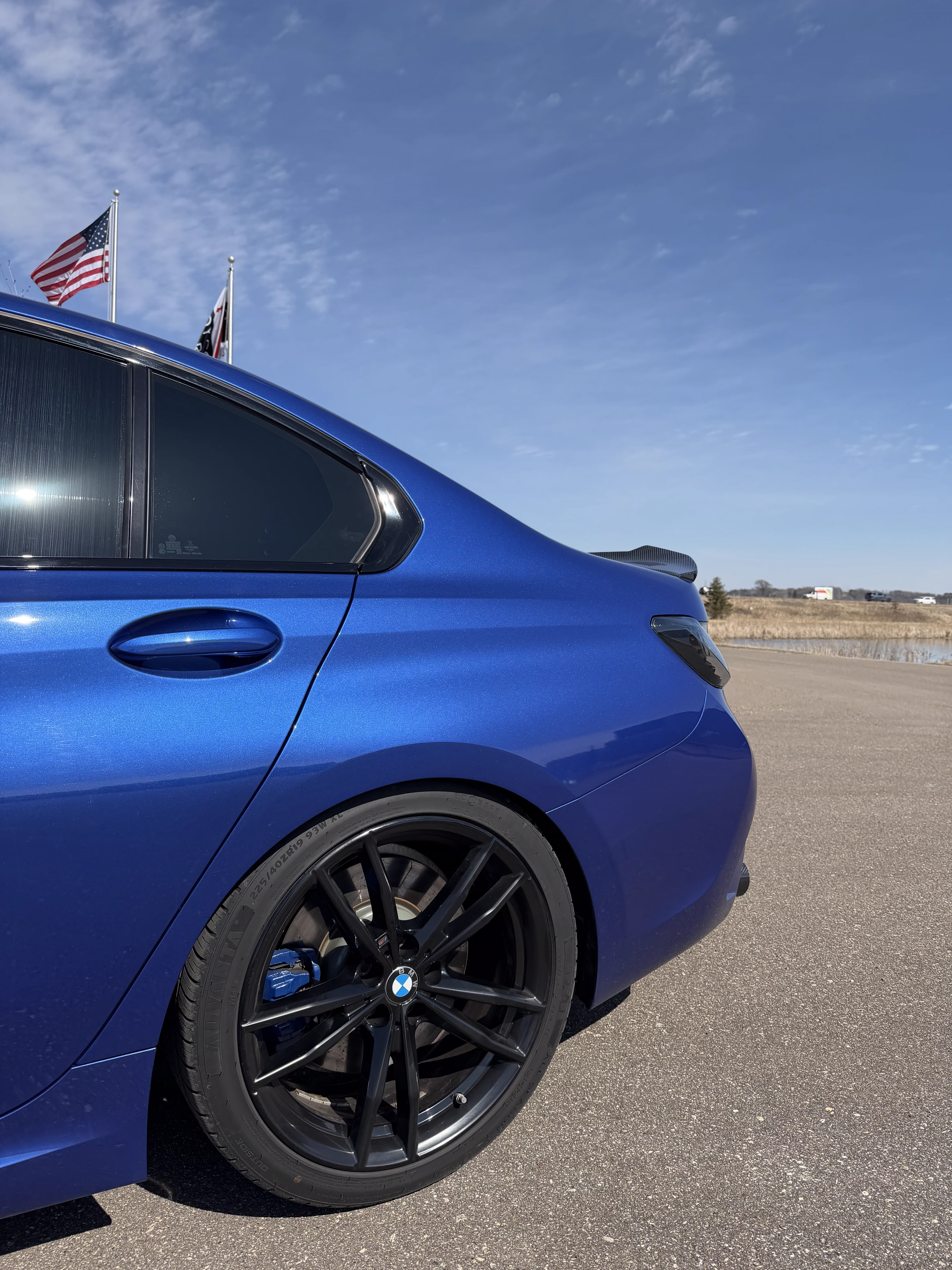 BMW 3 Series wheel, caliper, and carbon spoiler after chassis work